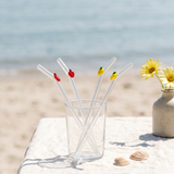 Set of four glass straws with colorful fruit decorations from Flying Tiger Copenhagen, ideal for fresh beverages.
