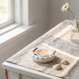 White ceramic seashell tealight holder with a 10 cm base, designed for home decor by Flying Tiger Copenhagen.