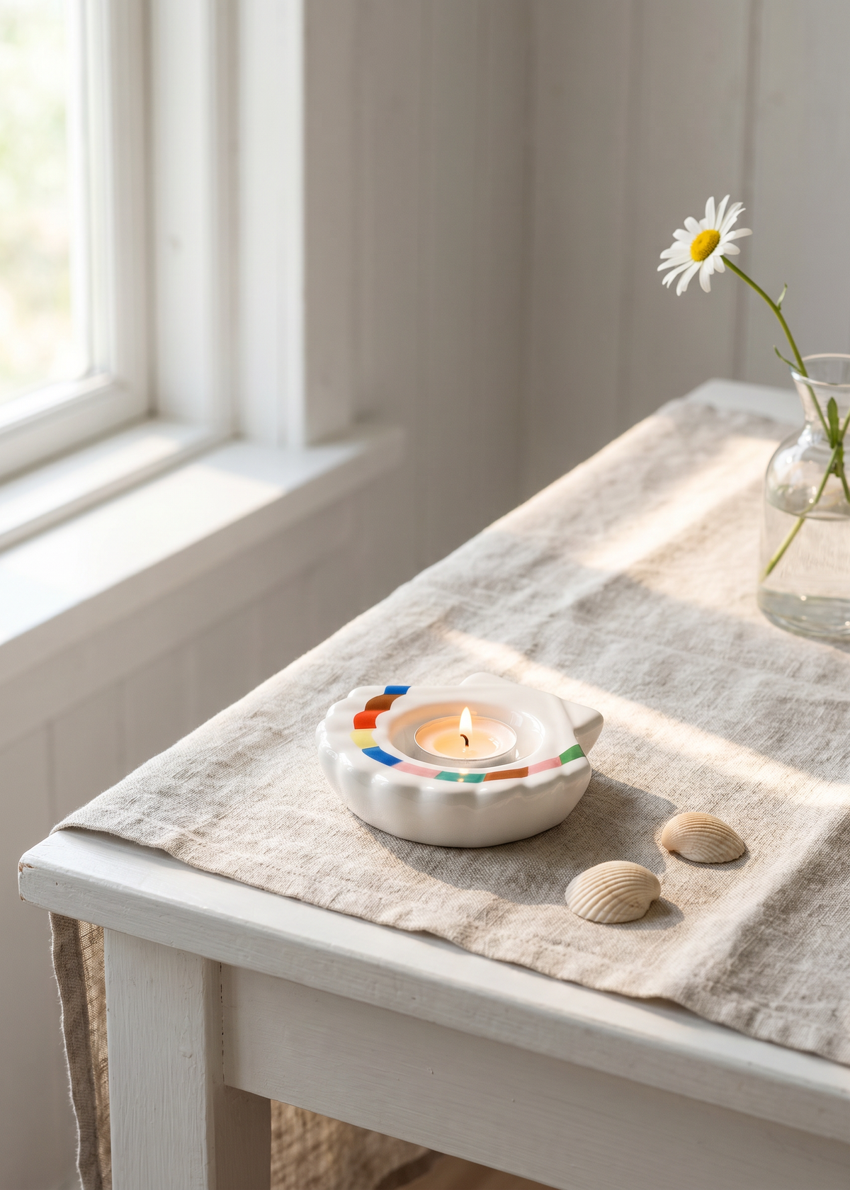 White ceramic seashell tealight holder with a 10 cm base, designed for home decor by Flying Tiger Copenhagen.