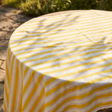 Yellow striped tablecloth from Flying Tiger Copenhagen, 140x220 cm, with bold yellow and white stripes on a smooth fabric surface.
