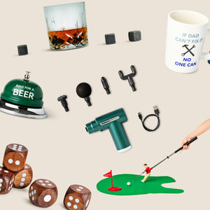 Flat lay of Father’s Day gift ideas on a beige background, including a “Ring for a Beer” bell, whiskey glass with ice stones, massage gun with attachments, “If Dad can’t fix it no one can” mug, golf putting set, and large wooden dice.