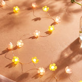 String lights featuring pink and yellow flower designs, decorative home lighting by Flying Tiger Copenhagen.