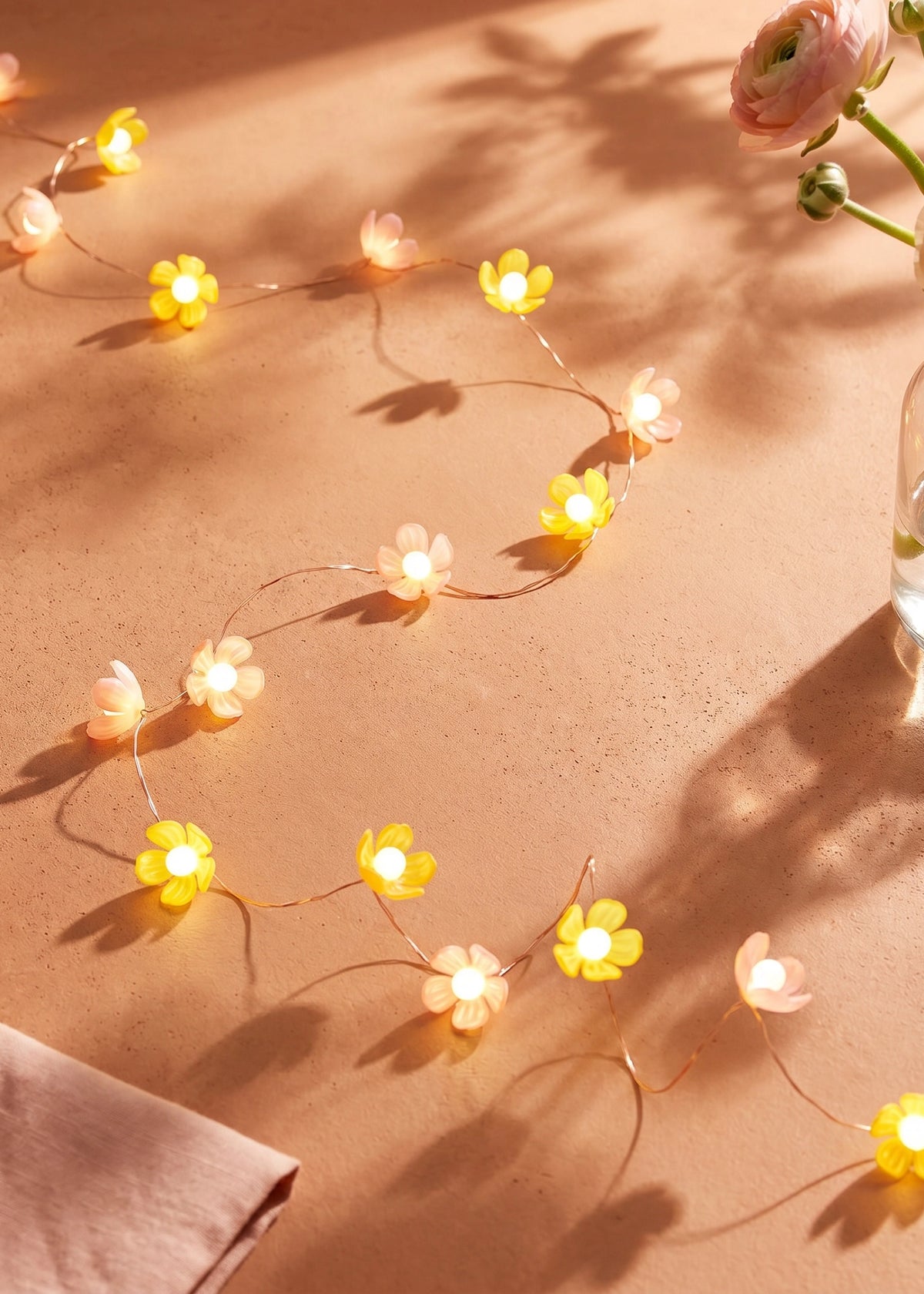 String lights featuring pink and yellow flower designs, decorative home lighting by Flying Tiger Copenhagen.