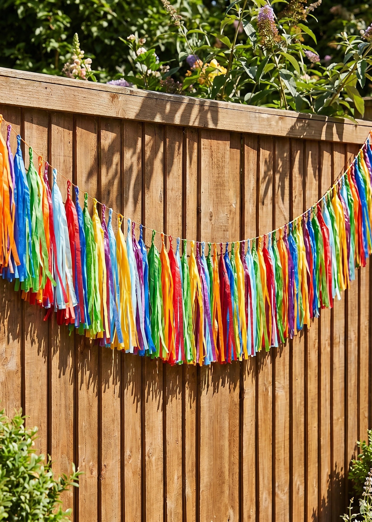 Colorful party garland with paper tassels, 300 cm long, ideal for summer garden celebrations by Flying Tiger Copenhagen.