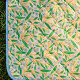 Flying Tiger Copenhagen quilted blanket in summer garden style, measuring 170x130 cm, with floral and leafy patterns.