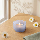 Milky blue glass tealight holder for home decor, designed by Flying Tiger Copenhagen, with a smooth, rounded shape and transparent finish.