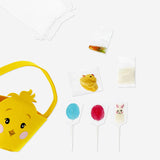 Colorful candy mix in a felt Easter chicken basket, featuring assorted sweets from Flying Tiger Copenhagen, perfect for Easter treats.