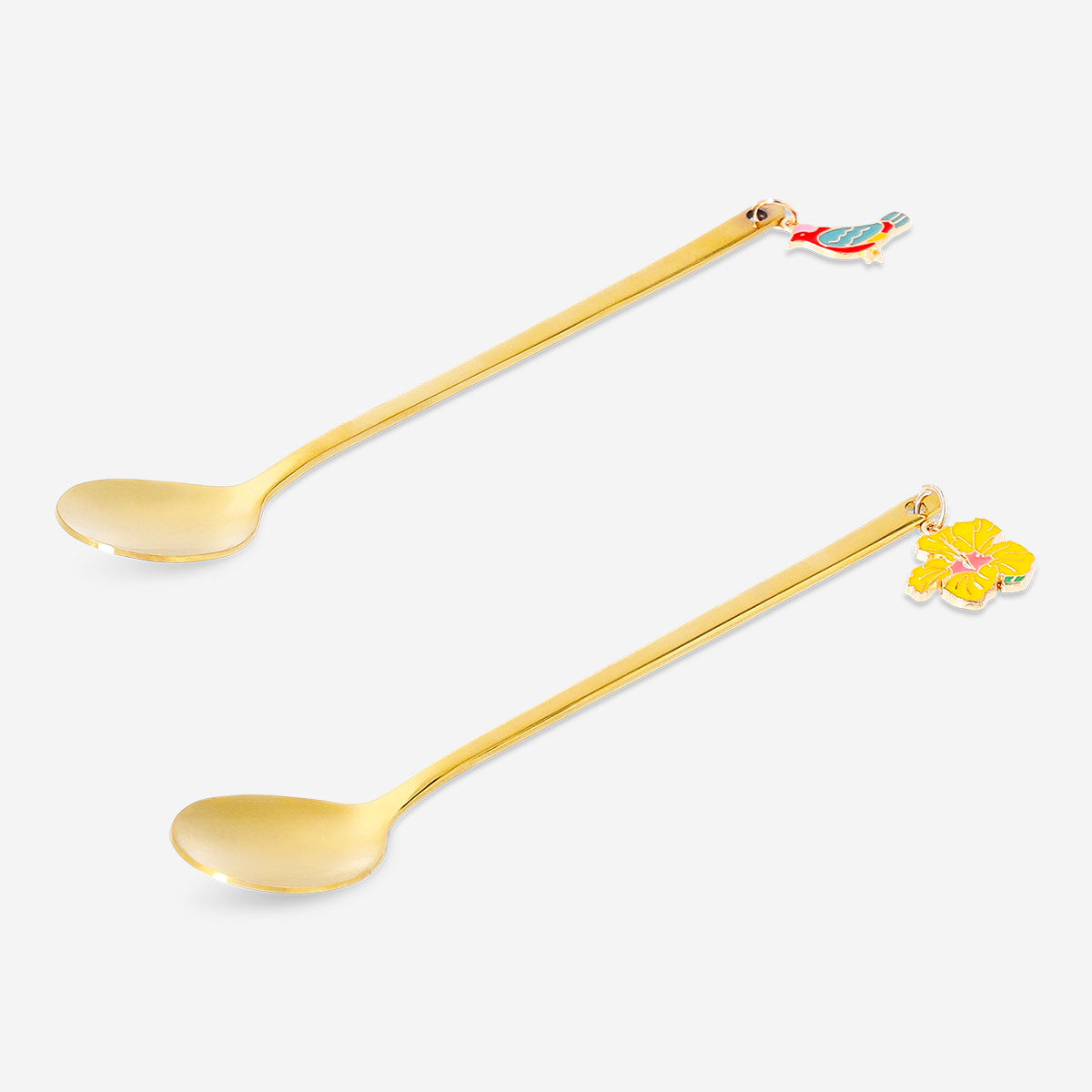 Two gold dessert spoons with tropical flower decorations from Flying Tiger Copenhagen for elegant kitchen use.