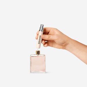 Beige refillable 8ml travel perfume bottle by Flying Tiger Copenhagen, compact and portable for on-the-go fragrance.