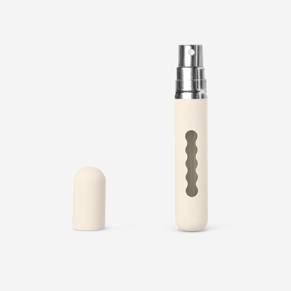 Beige refillable 8ml travel perfume bottle from Flying Tiger Copenhagen, compact and portable for on-the-go fragrance.