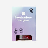 Shimmering purple glitter eyeshadow flakes from Flying Tiger Copenhagen, used for eye makeup and personal care.