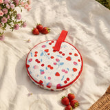 Flying Tiger Copenhagen picnic set for 2 persons with plates, cups, and utensils displayed on a wooden table.