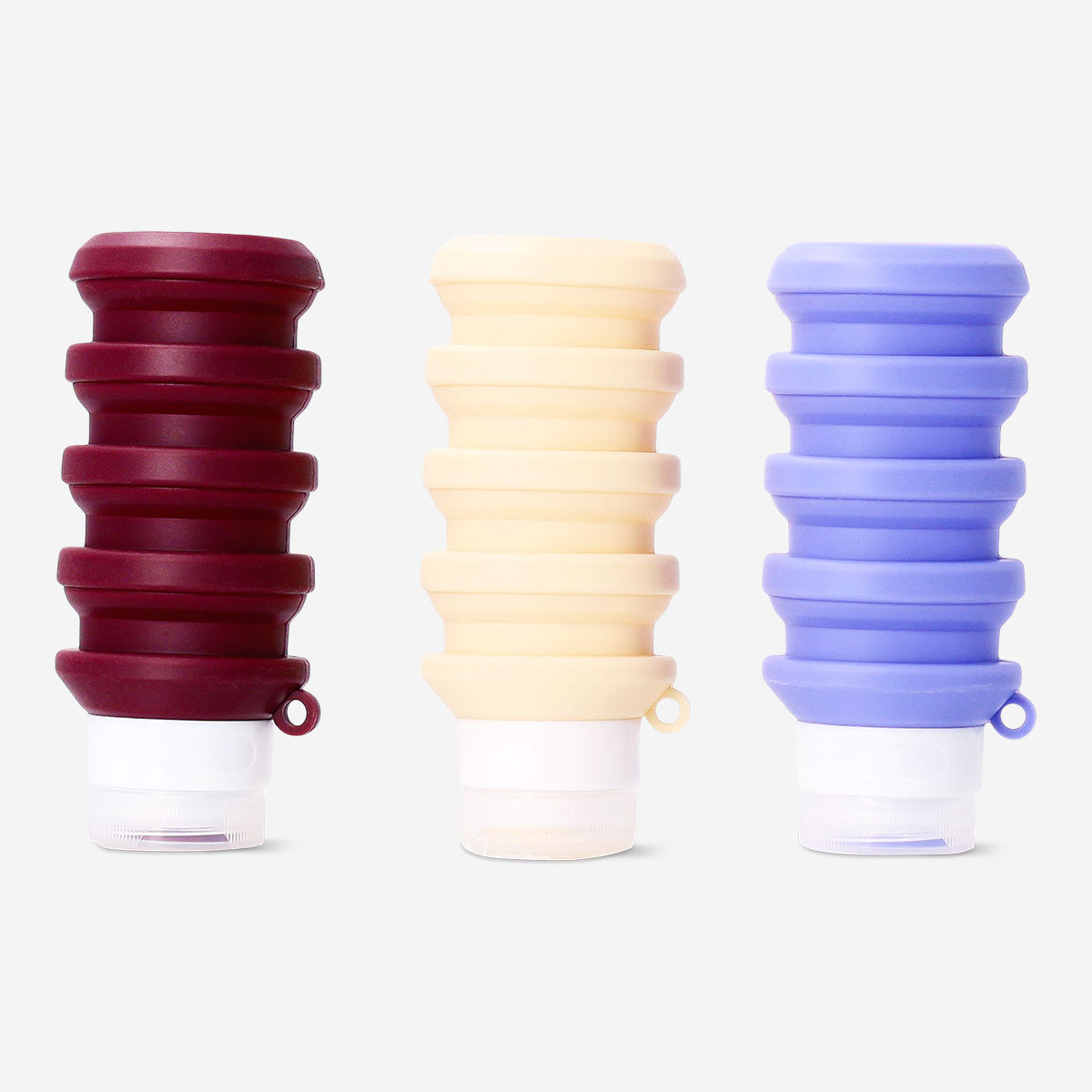 Three foldable silicone travel bottles in assorted colors, ideal for leisure trips, by Flying Tiger Copenhagen.