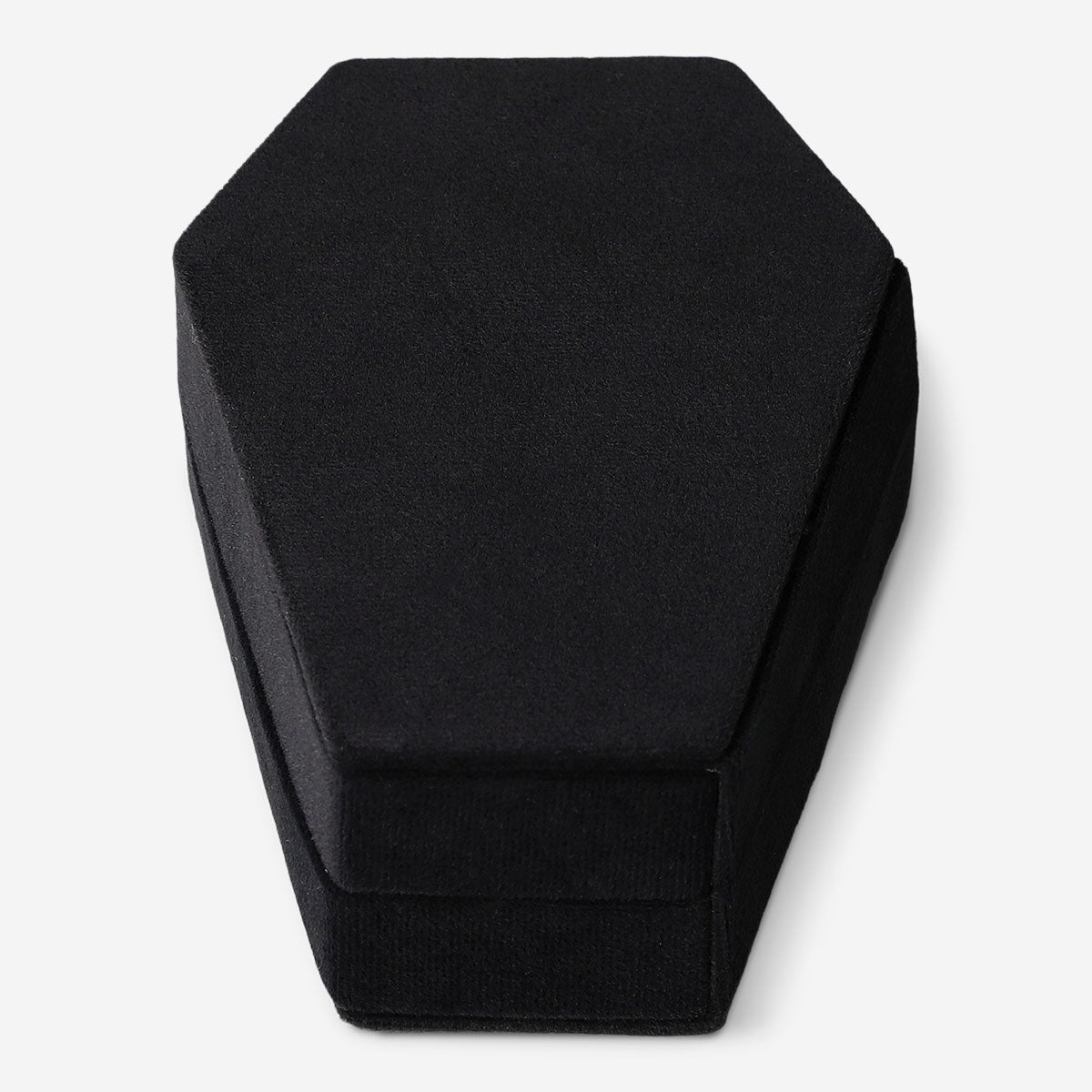 Black coffin-shaped jewelry storage container from Flying Tiger Copenhagen, designed for personal care and organization.