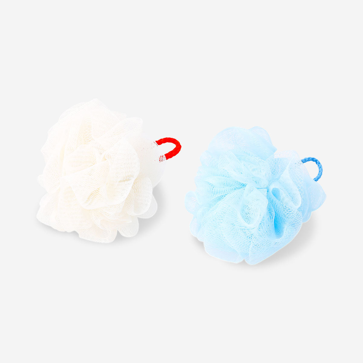 Two Flying Tiger Copenhagen bath sponges for personal care, soft and exfoliating, shown with textured surfaces and vibrant colors.