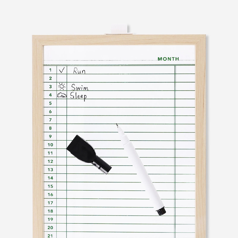 Glass planner board with marker for office use by Flying Tiger Copenhagen, featuring a sleek transparent surface with handwritten notes.