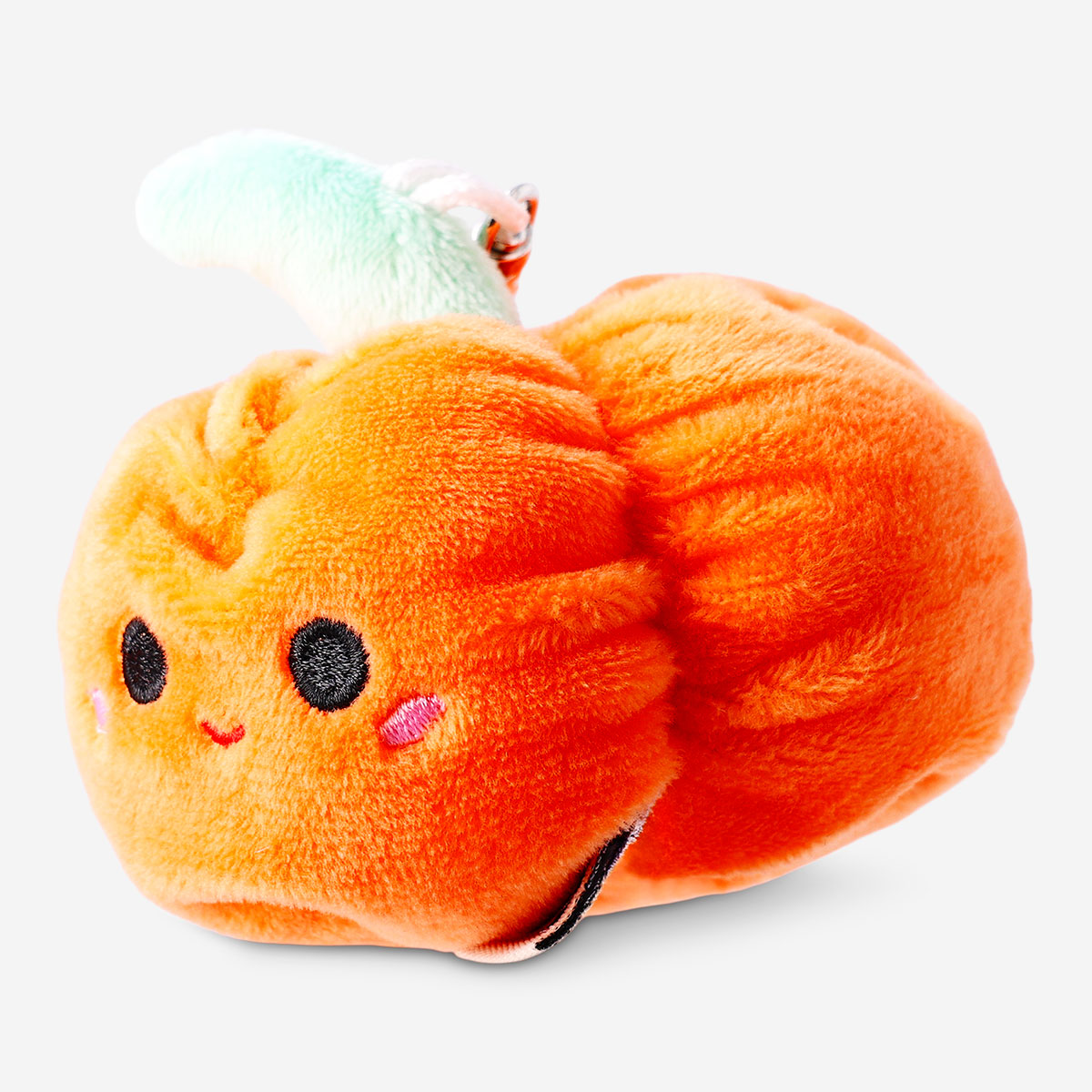Plush toy pumpkin keychain from Flying Tiger Copenhagen featuring a soft, orange pumpkin with a cute face and green stem detail.