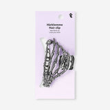 Skeleton hair clip made of textile from Flying Tiger Copenhagen, featuring a detailed skeleton design for stylish hair accessories.