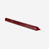 Burgundy dinner candle from Flying Tiger Copenhagen, 24 cm tall, placed on a dining table for home decor or ambiance.