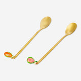 Two gold dessert spoons with colorful fruit decorations from Flying Tiger Copenhagen, ideal for elegant table settings.