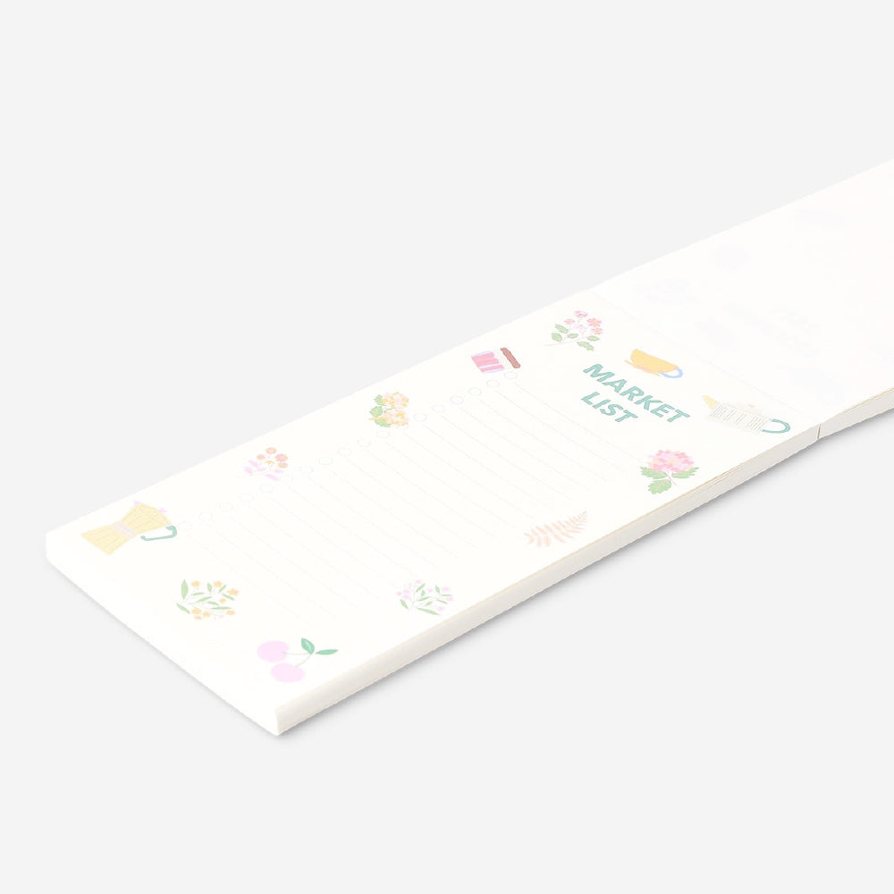 Flying Tiger Copenhagen shopping list notepad for office use, featuring a colorful, compact design with handwritten notes on paper.