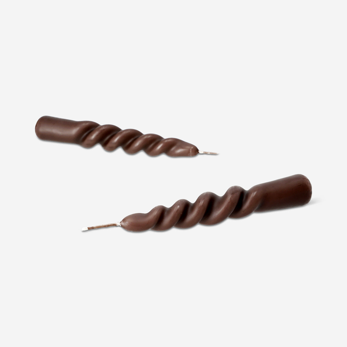 Two brown twisted dinner candles from Flying Tiger Copenhagen, ideal for home table settings and decorative lighting.