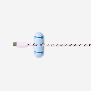 Two blue adhesive cable organizers from Flying Tiger Copenhagen for managing and securing media cables.