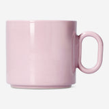 Pink ceramic mug with oval handle from Flying Tiger Copenhagen, 313 ml capacity, part of the Designer Collection, on a kitchen countertop.