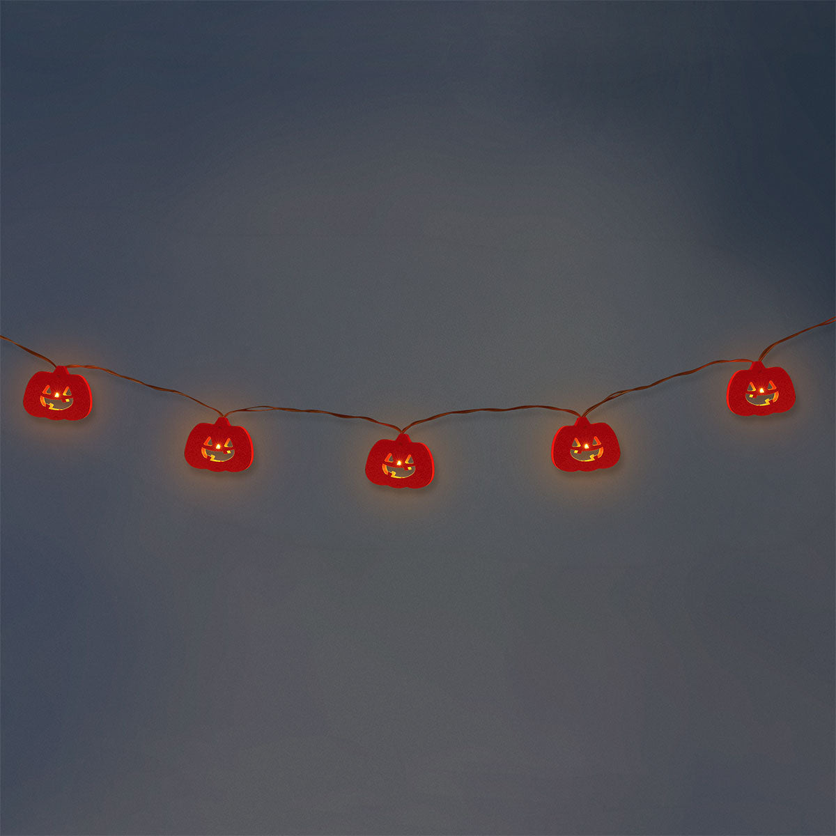 Flying Tiger Copenhagen Halloween pumpkin string lights hanging with orange pumpkin-shaped bulbs for festive home decor.