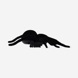Black vibrating spider toy from Flying Tiger Copenhagen showing the textured body and multiple legs.