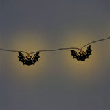 Black bat-shaped string lights for home decor by Flying Tiger Copenhagen, featuring a string of spooky bat-shaped LED lights.