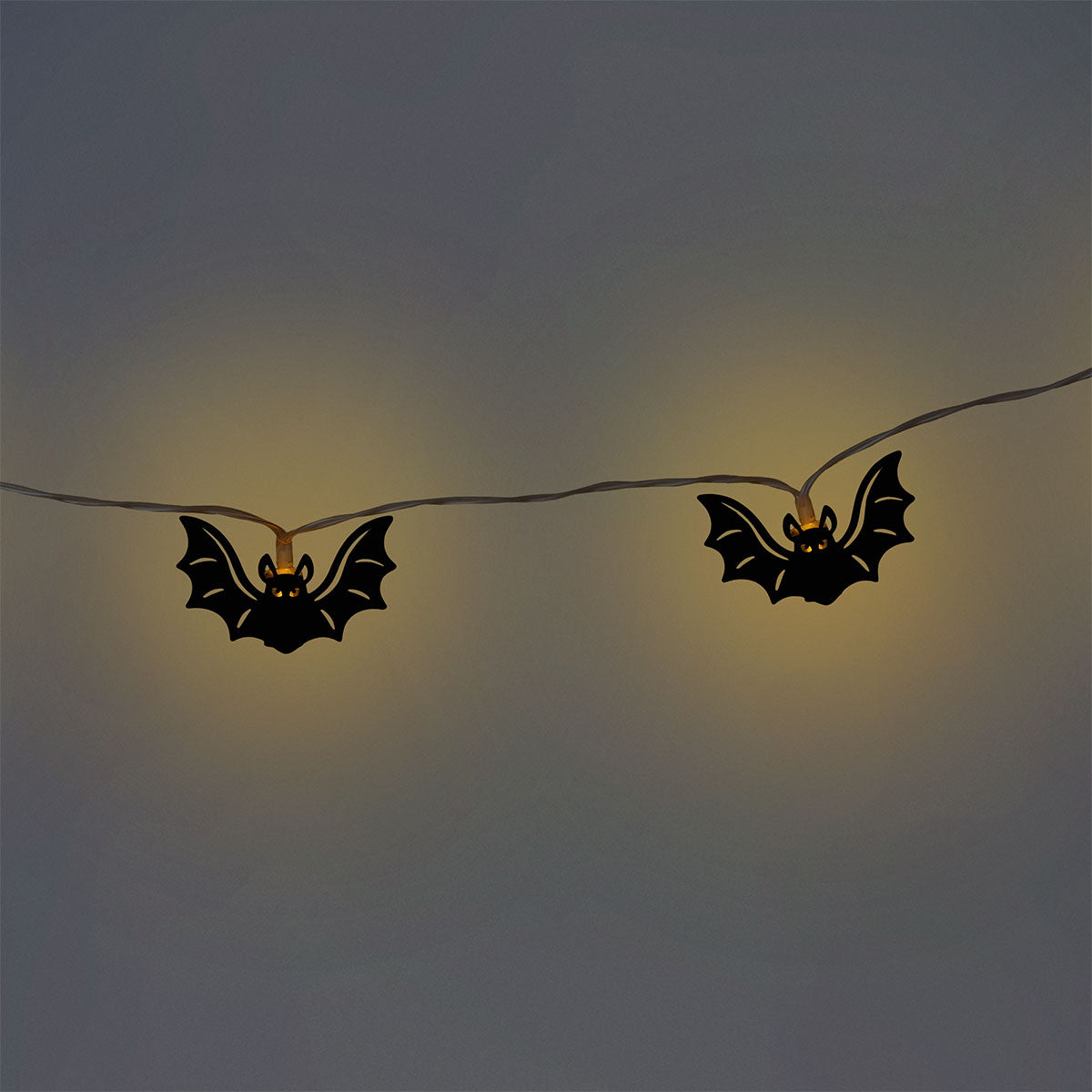 Black bat-shaped string lights for home decor by Flying Tiger Copenhagen, featuring a string of spooky bat-shaped LED lights.