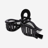 Black textile bow hairclip with a sleek, classic design, perfect for adding a stylish touch to hairstyles.