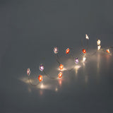 Flying Tiger Copenhagen string lights with purple and pink flower designs, perfect for home decor.