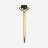 Flying Tiger Copenhagen gold ballpoint pen with built-in facial roller, ideal for office use and quick skincare refreshes.