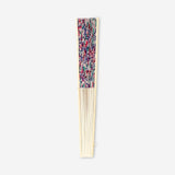 Foldable bamboo fan with colorful floral textile design by Flying Tiger Copenhagen, showcasing vibrant multi-colored flower patterns.