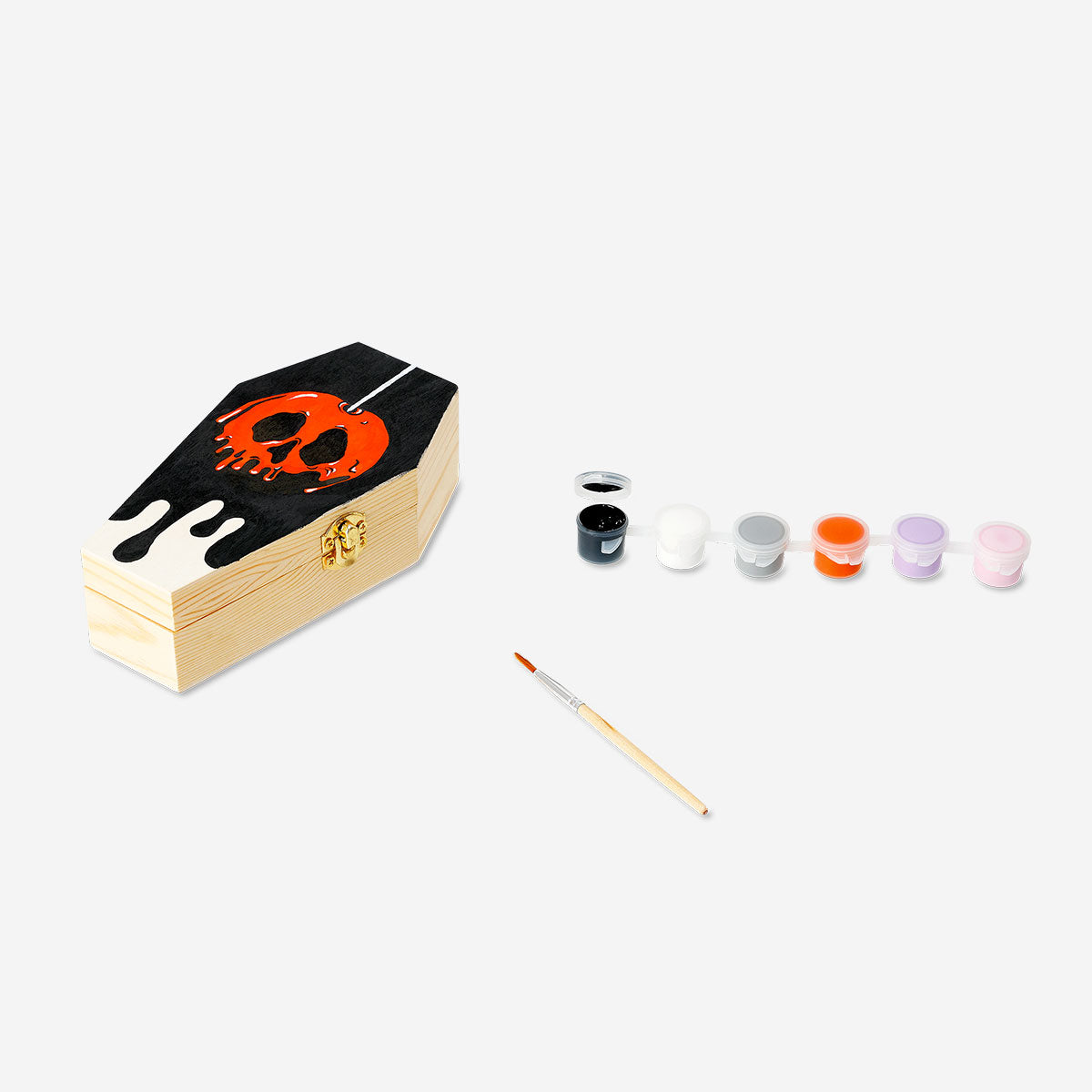 DIY wooden coffin hobby kit with paint from Flying Tiger Copenhagen, showing painted wooden coffin and craft supplies.