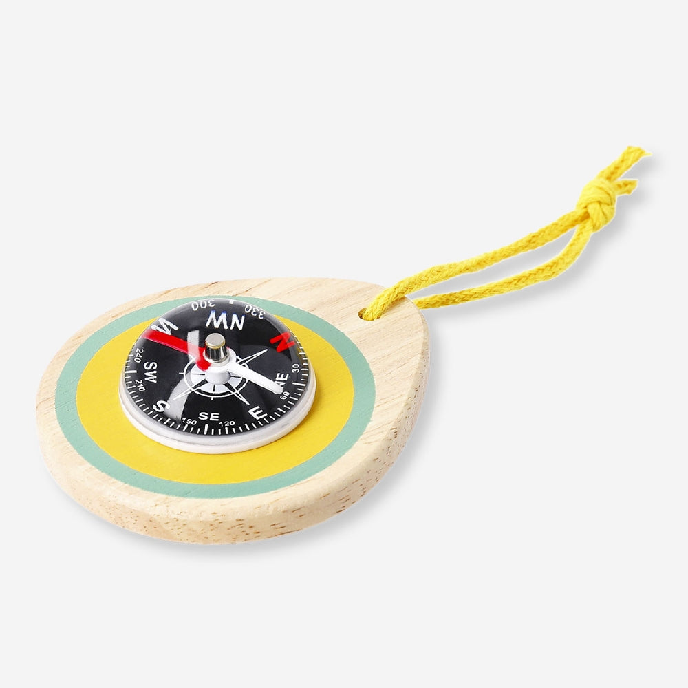 Wooden toy compass from Flying Tiger Copenhagen showing a classic design with a rotating arrow and printed directions on the face.