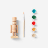 DIY wooden nutcracker hobby kit by Flying Tiger Copenhagen, showing unassembled wooden parts for craft project.