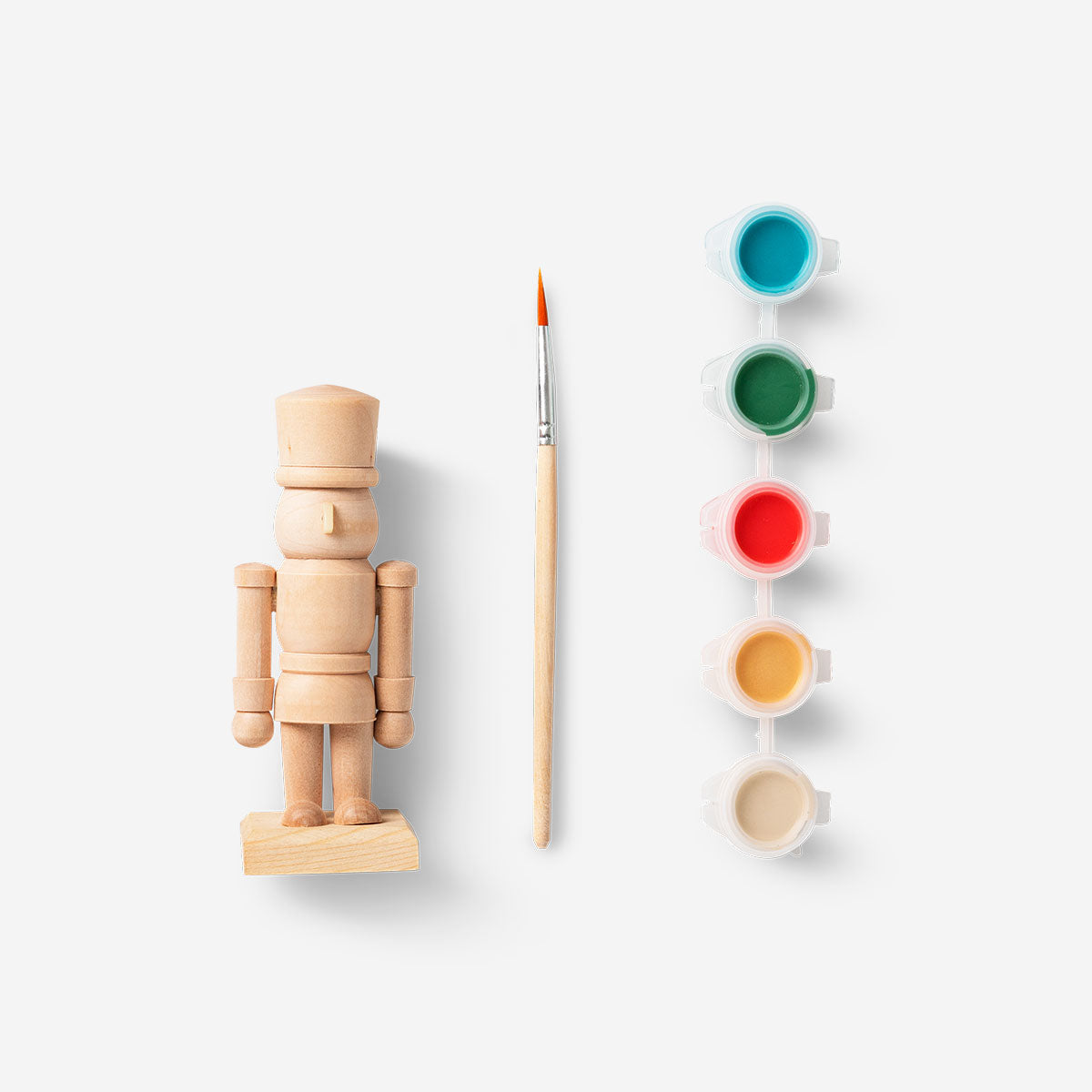 DIY wooden nutcracker hobby kit by Flying Tiger Copenhagen, showing unassembled wooden parts for craft project.