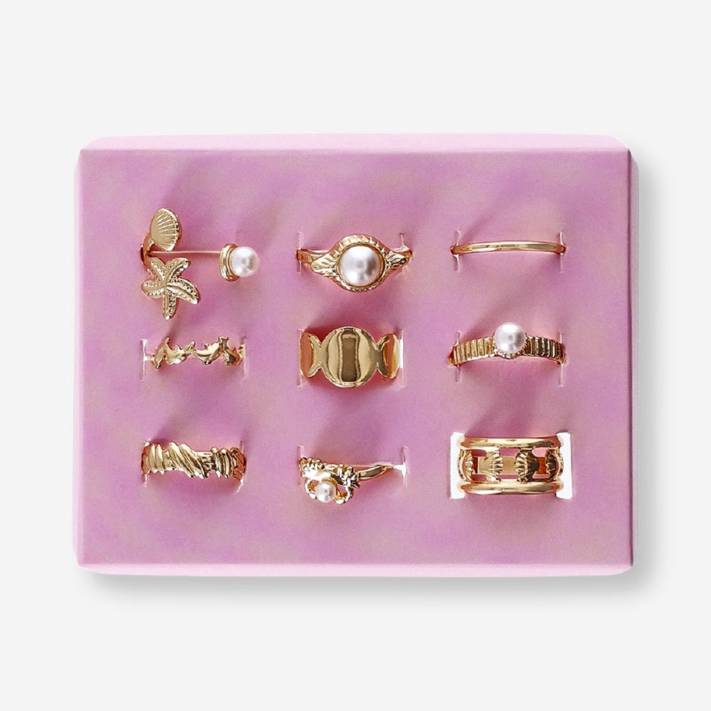 Set of nine adjustable textile rings featuring sea icon designs from Flying Tiger Copenhagen on a neutral background.