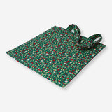 Green textile tote bag with holly leaf pattern from Flying Tiger Copenhagen, featuring sturdy handles and festive holiday design.