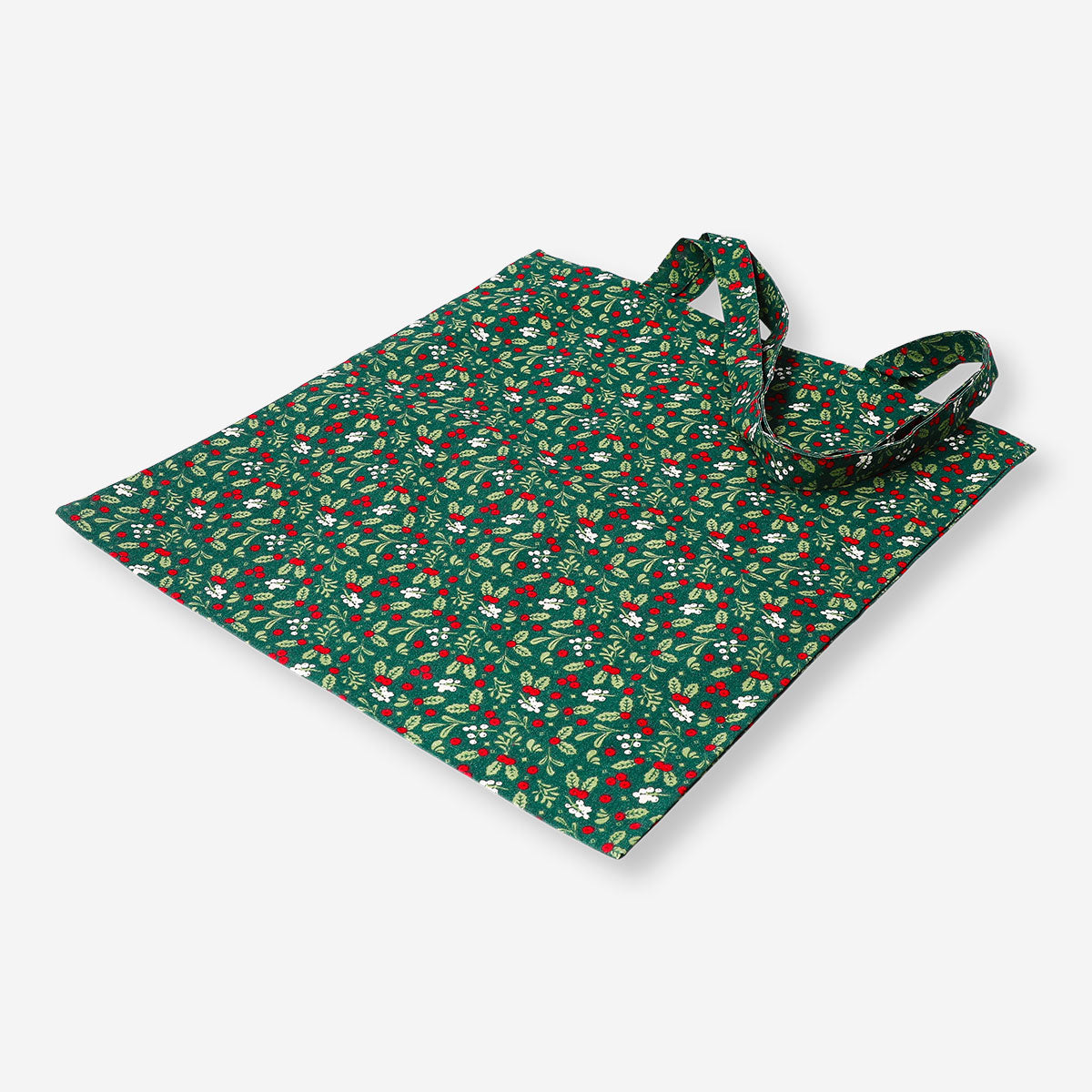 Green textile tote bag with holly leaf pattern from Flying Tiger Copenhagen, featuring sturdy handles and festive holiday design.