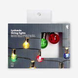 Multi-colored outdoor string lights from Flying Tiger Copenhagen hanging in a home setting, ideal for outdoor decor and ambiance.