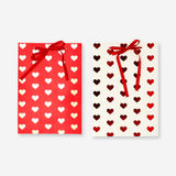 Two foil heart gift bags from Flying Tiger Copenhagen, ideal for office gift wrapping, featuring shiny heart patterns.