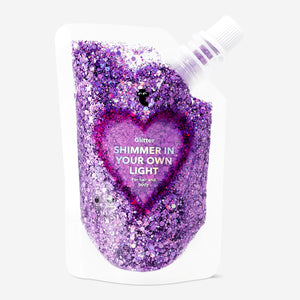 Purple glitter for hair and body, Flying Tiger Copenhagen personal care product, shown on a light background.