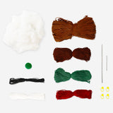 DIY crochet Christmas sausage dog hobby kit by Flying Tiger Copenhagen featuring colorful yarn and crochet tools.