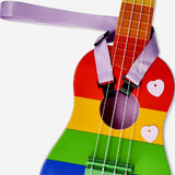 Rainbow-colored ukulele with strap by Flying Tiger Copenhagen, showing the vibrant instrument and attached strap.