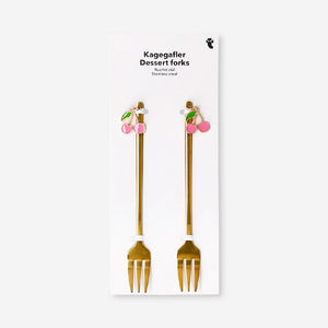 Pair of gold dessert forks with cherry decorations from Flying Tiger Copenhagen, perfect for elegant kitchen serving.
