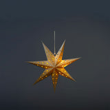 White glowing paper star from Flying Tiger Copenhagen, ideal for home decor and ambient lighting.